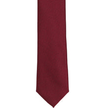 Load image into Gallery viewer, The front of a burgundy textured skinny tie, laid out flat
