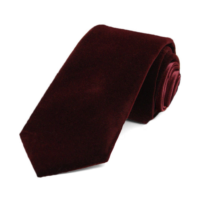 Velvet necktie in burgundy, rolled to show off fabric