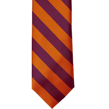 Load image into Gallery viewer, The front of a burnt orange and raspberry striped tie, laid out front