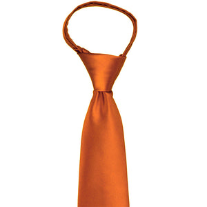 Knot and front of a burnt orange zipper tie