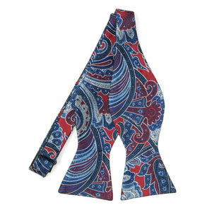 An untied red and blue large print paisley self-tie bow tie