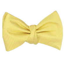 Load image into Gallery viewer, A tied self-tie bow tie in a butter yellow herringbone pattern