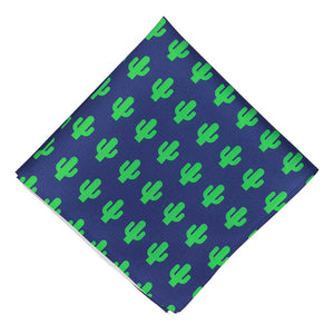 A dark blue pocket square, folded into a diamond, with a bright green repeated cactus pattern
