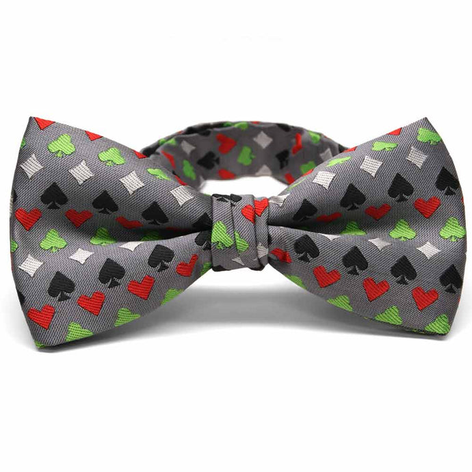 Green, white, black and red card suit casino pattern bow tie on gray background