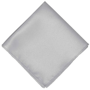 A silver toned pocket square, folded into a diamond shape