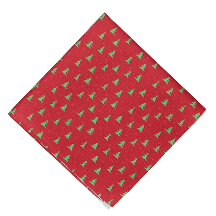 A red pocket square with small scattered Christmas trees, folded into a diamond