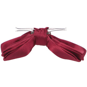 The side view of a claret red clip-on bow tie
