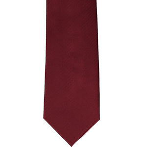 The front of a claret red herringbone tie, laid flat