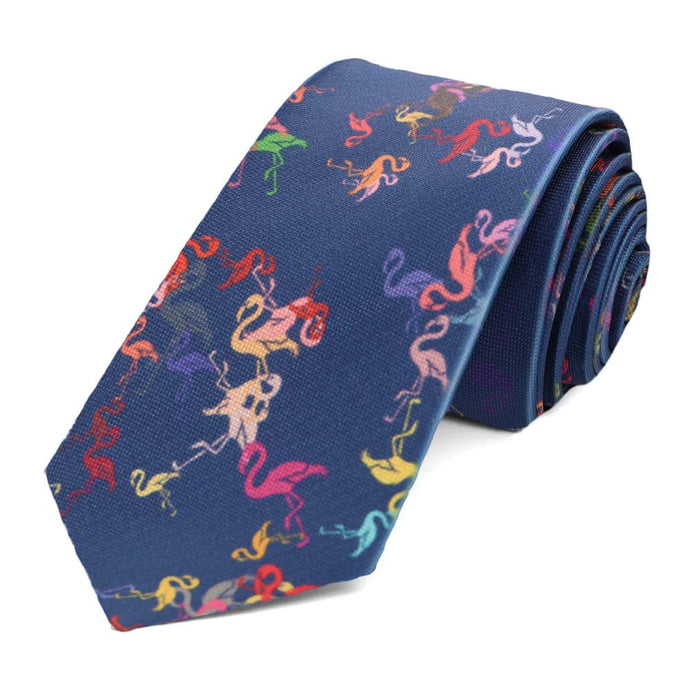A dark blue slim tie, rolled, with color flamingos scattered all over it