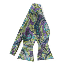 Load image into Gallery viewer, An untied purple self-tie bow tie with a light green and turquoise paisley pattern