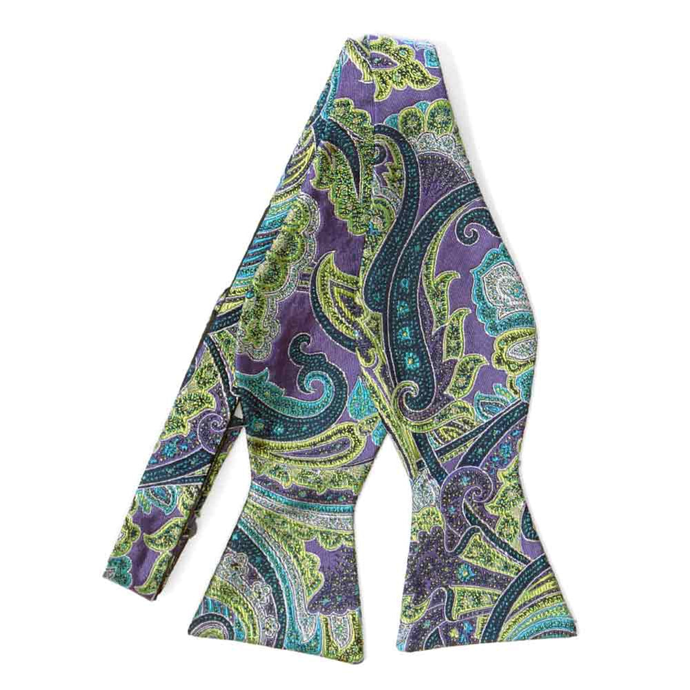 An untied purple self-tie bow tie with a light green and turquoise paisley pattern