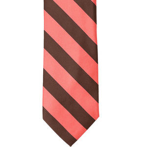 The front of a coral and brown striped tie, laid out flat