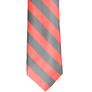 The front of a coral and gray striped tie, laid out flat