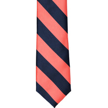 Load image into Gallery viewer, The front of a coral and navy striped tie, laid out flat