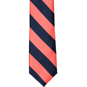 The front of a coral and navy striped tie, laid out flat
