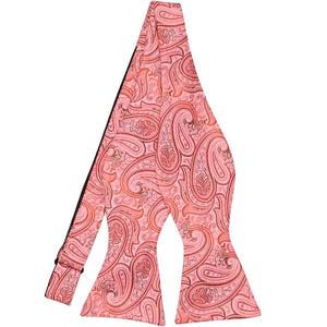 A detailed coral paisley self-tie bow tie, untied
