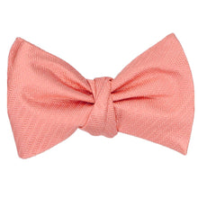 Load image into Gallery viewer, A light coral self-tie bow tie, tied, in a herringbone tone on tone pattern