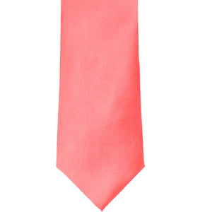 The front of a coral solid color tie, laid out flat