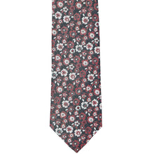 Load image into Gallery viewer, The bottom front of a crimson red and white floral tie on a black background