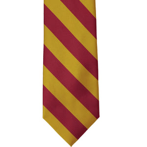 Front view of a crimson red and gold striped tie, laid out flat