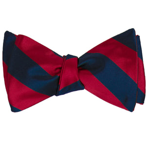 Crimson red and navy blue striped self-tie bow tie, tied