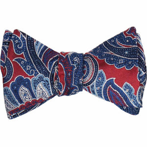 A crimson red paisley bow tie, tied