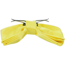 Load image into Gallery viewer, A daffodil yellow clip-on bow tie, opened to show how the clips work