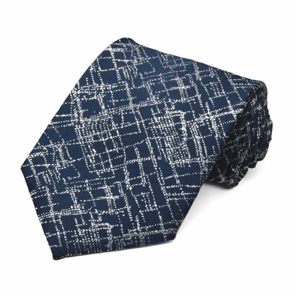 Dark blue necktie rolled to show abstract silver crosshatch pattern
