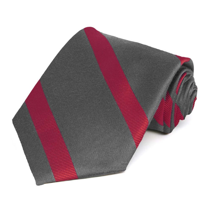 Dark gray and red striped necktie rolled to show the texture of the red stripes
