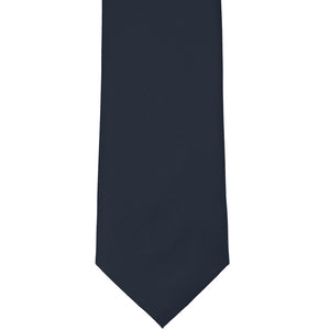 The front tip of a dark navy blue solid color tie