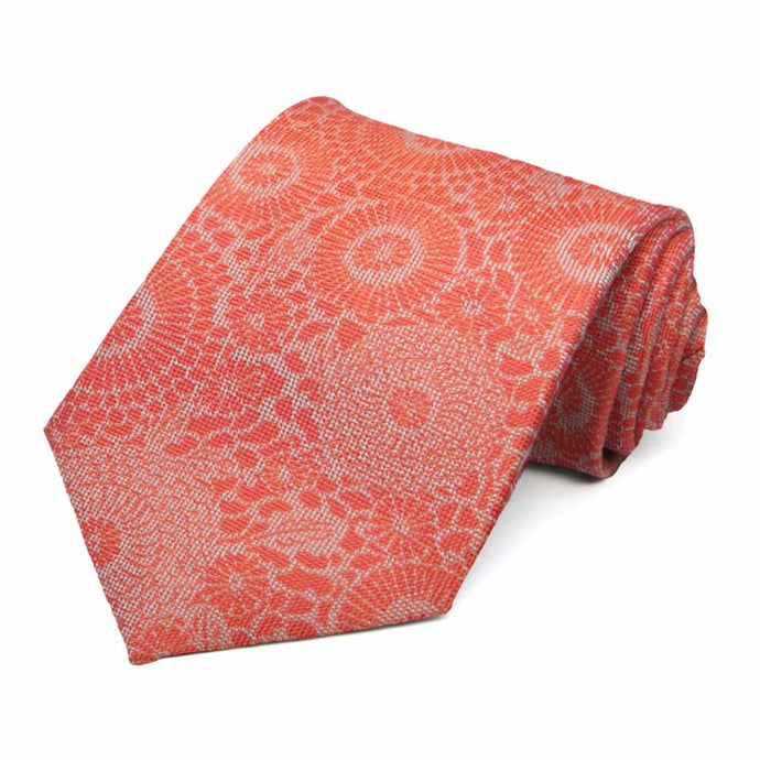 Textured dark orange floral necktie rolled to show pattern