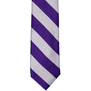 The front of a dark purple and silver striped tie, laid out flat