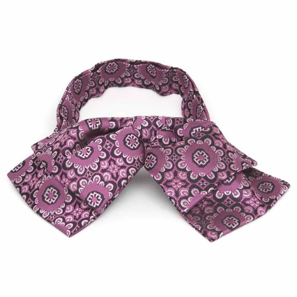 Front view of a deep magenta floral pattern floppy bow tie