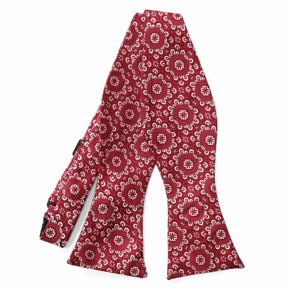 Flat front view of an untied red and white floral pattern self-tie bow tie