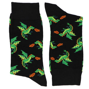 A pair of black socks, folded, with a green dragon pattern