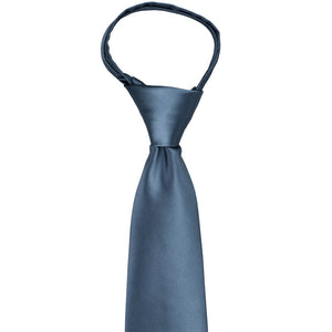 The knot and neck loop on a dusty blue zipper tie
