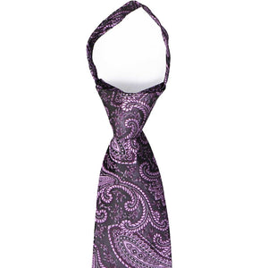 The knot on an eggplant purple paisley zipper tie