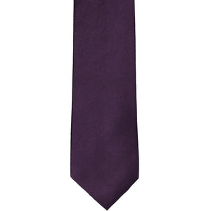The front of an eggplant purple slim tie, laid out flat
