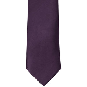 The front of an eggplant purple solid tie, laid out flat