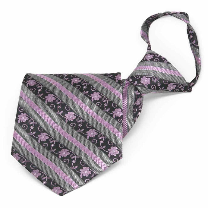 Folded front view of a lavender and gray floral stripe zipper style tie