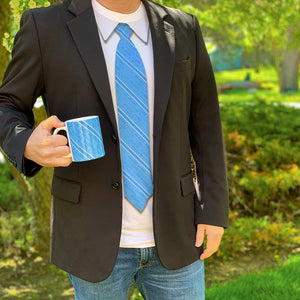 A man outside wearing a necktie tshirt under a black suit jacket