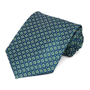 A blue textured necktie with small bright green flowers and pin point dots