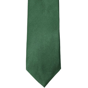 The front of a forest green solid tie, laid out flat