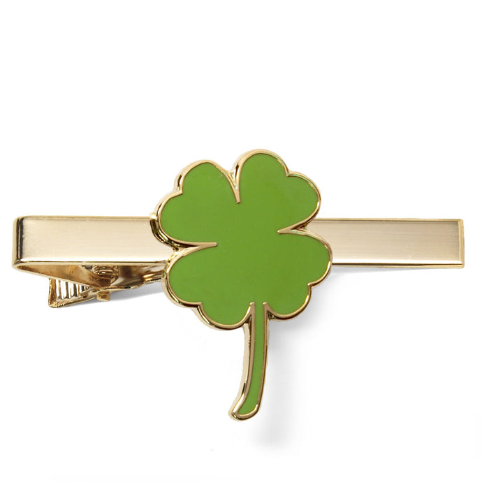 Green shamrock leaf on a gold tie bar.