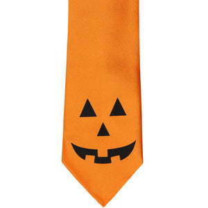 Orange tie with a jack-o-lantern face at the base of the tie