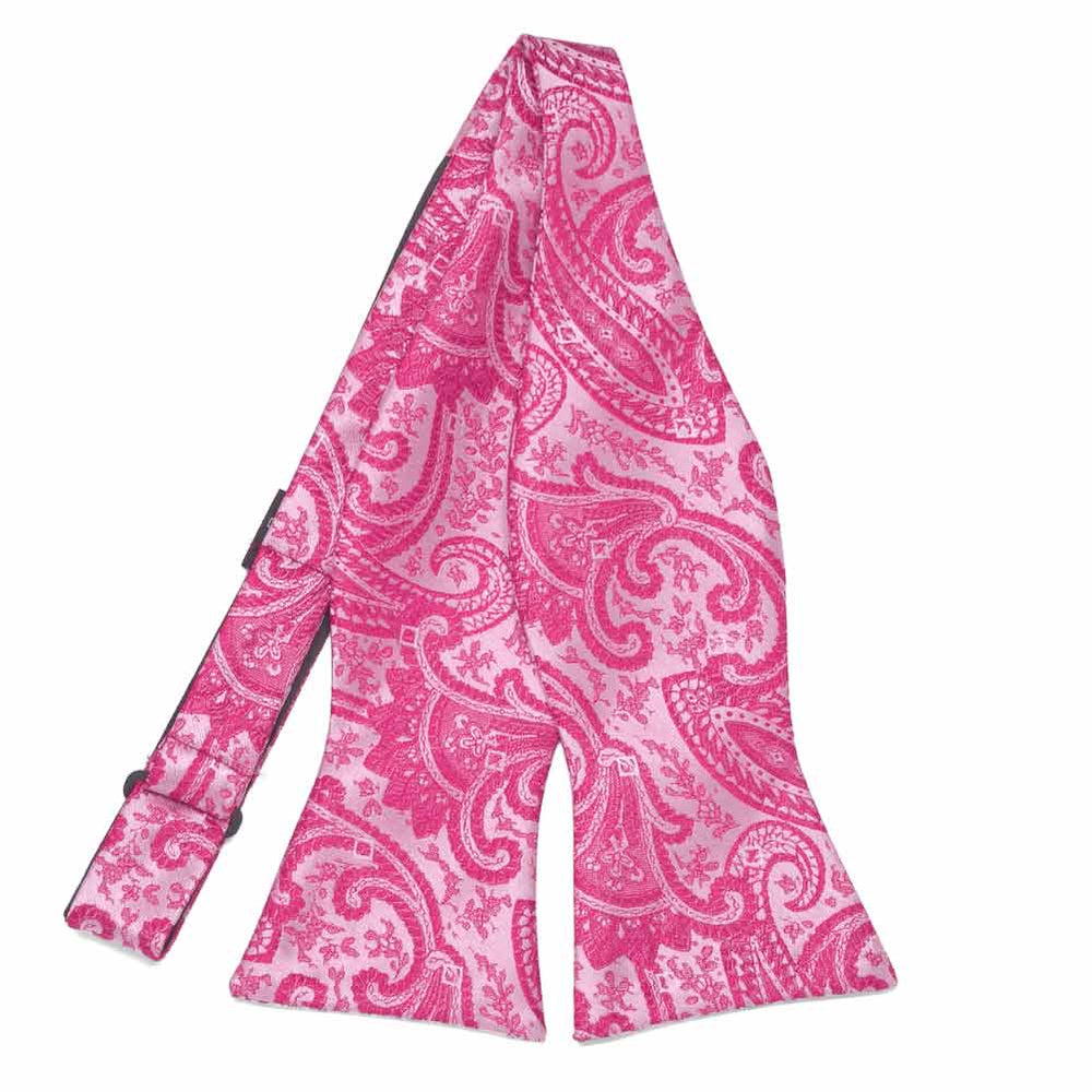 Bright fuchsia paisley self-tie bow tie, untied flat front view