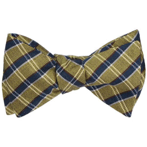 A tied self-tie bow tie in a gold and navy plaid