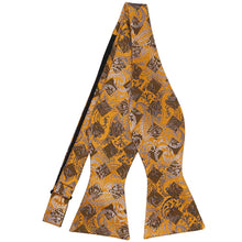 Load image into Gallery viewer, An untied paisley bow tie in shades of gold bar, black and silver