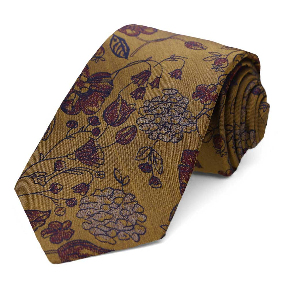 An old gold floral necktie, rolled to show the pattern up close