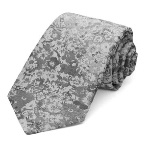 A gray tone-on-tone floral tie, rolled to show off the pattern